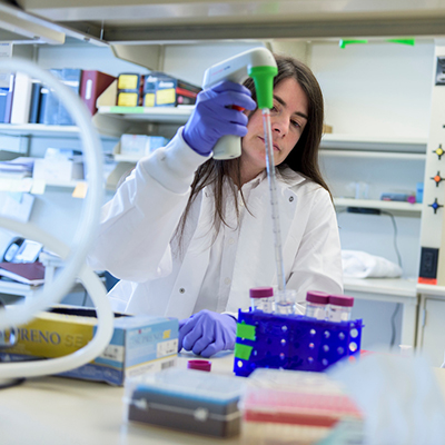 Dr. Laura Smith pipeting a solution into a vial