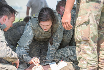 soldier medical student learning on simulated patient